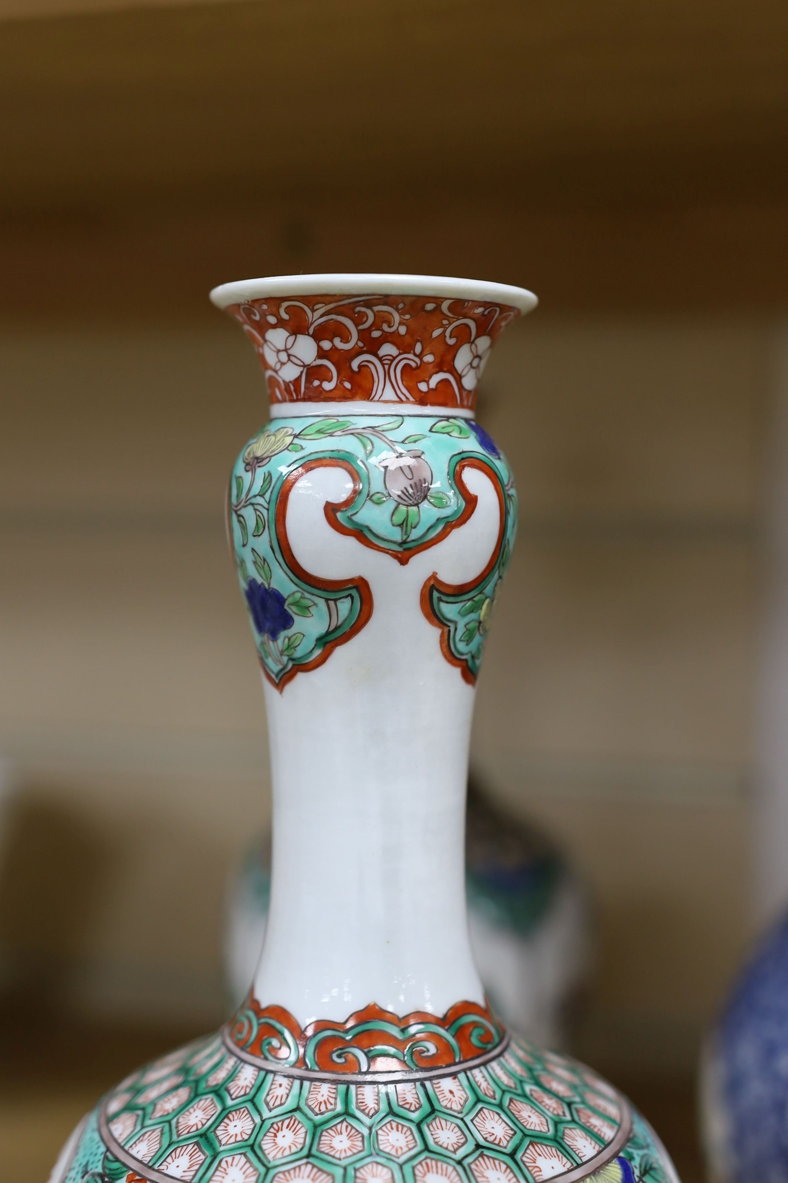 A pair Samson of Paris vases in the Chinese famille verte style and a Chinese Qianlong famille rose garlic neck vase with blue panelling motif, tallest 26cm